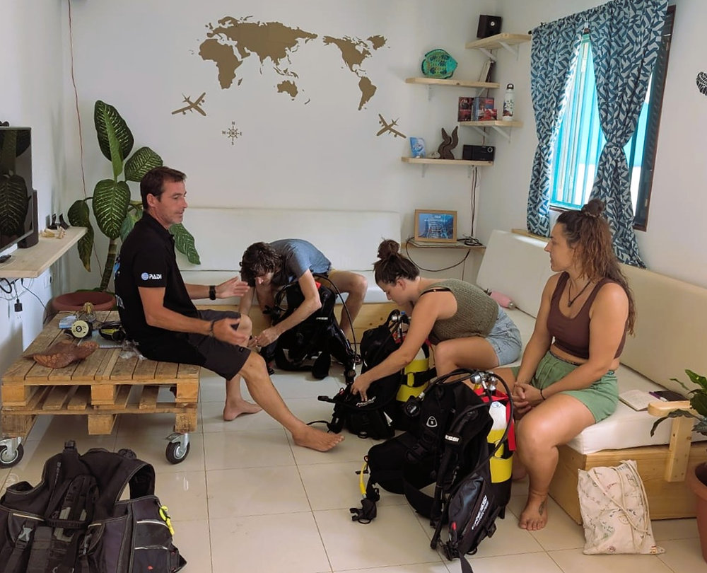 PADI scuba diving course students assembling equipment with instructor at Cidade Velha Diving center, Cape Verde
